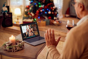 Naklejka na ściany i meble Happy multi-generation family gathering via video call on Christmas day.