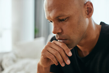 Close-up of thoughtful black man at home.