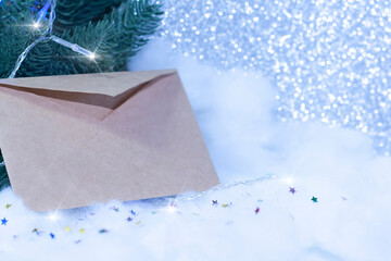 An envelope for writing in the snow with a spruce branch and red berries. Stars in the snow. Christmas decoration with fir branches and berries in snow