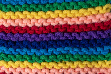 background of stripes in rainbow colours - hand knitting 