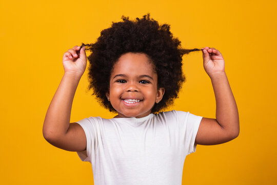 cute afro girl with black power hair smiling at camera. Black Day. Children's Day