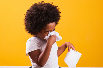 Allergies or cold concept. little afro girl wiping her cold nose