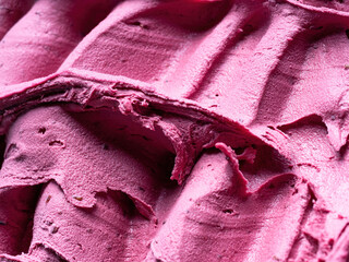 Frozen Black Elderberry flavour gelato - full frame detail. Close up of a pink surface texture of...