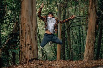 young teenage jumping in the forest outdoors