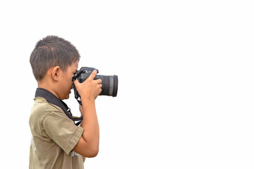 Fototapeta na wymiar Asian boy holding a digital camera or DSLR to taking a photo isolated on white background.