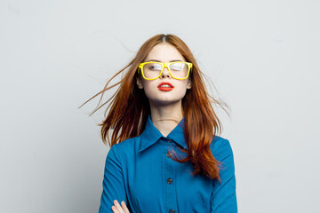 woman in blue shirt yellow glasses posing fashion