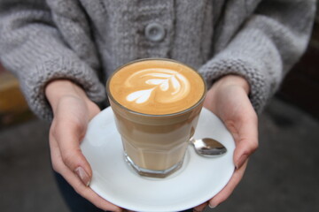 Professional latte art pattern. Coffee being served. People have coffe break.