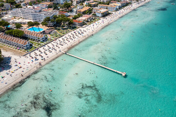 Fototapeta premium Aerial drone photo of the beach front on the Spanish island Majorca Mallorca, Spain showing the beach known as Platja de Muro in the village of Alcúdia on a sunny summers days