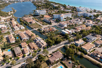 Aerial drone photo of the beach front on the Spanish island Majorca Mallorca, Spain showing the beach known as Platja de Muro in the village of Alcúdia on a sunny summers days