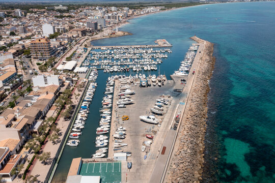 Aerial drone photo of the beach front on the Spanish island of Majorca Mallorca, Spain viewed from above on a bright sunny summers day showing the beach front in the village of Can Picafort