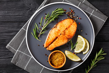 baked salmon steak on a plate, top view