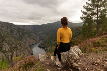 Fototapeta premium Panoramic of an impressive viewpoint of the Sil Canyon in the Ribeira Sacra with woman in foreground, Galicia