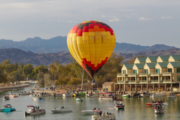 yellow hot air balloon floating over the river 