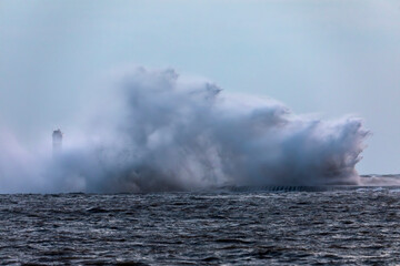 Waves crashing on a lighthouse on lake Michigan