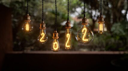 Obraz premium Light bulb New Year background. Edison light bulb. 2022 year. 3d rendering