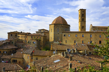Baptistery and the bell tower of the cathedral in Volterra, Province of Pisa, Tuscany, Italy - obrazy, fototapety, plakaty