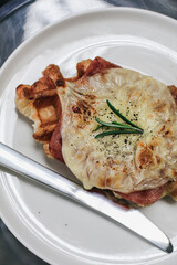 Delicious croissant Waffle or Croffle with ham cheese. Selective focus. Tasty breakfast sandwich or snack