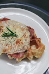 Delicious croissant Waffle or Croffle with ham cheese. Selective focus. Tasty breakfast sandwich or snack