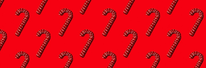 Christmas holiday pattern. Red canes on red background. Banner for website.