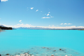Fototapeta premium View of milky blue of Lake Pukaki with beautiful view on Southern Alps in the background in South Island New Zealand