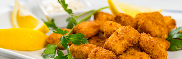 Crispy Fish Bites Snack Size. Deep Fried Pollock Fish Fingers with Tartar Dipping Sauce. Panoramic...