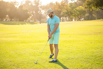 handsome man playing golf game on green grass, recreation
