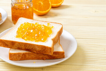 Naklejka na ściany i meble Slices of bread with orange jam