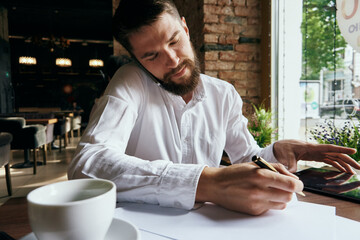 business man in a cafe with a tablet in his hands technology work