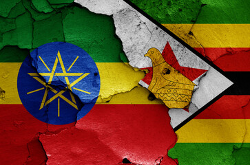flags of Ethiopia and Zimbabwe painted on cracked wall