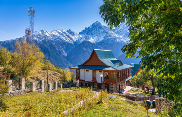 Wooden tourist lodge with scenic Himalaya mountain landscape at a hill station of Himachal Pradesh,...