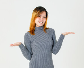 Portrait close up studio shot of Asian young teen female model in gray turtleneck sweater standing...