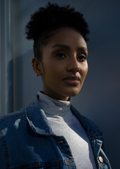 Portrait of a young woman in a blue denim jacket