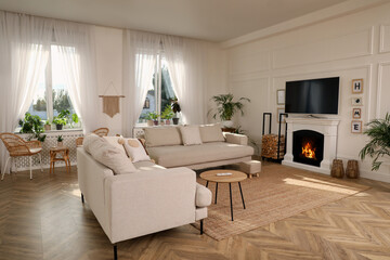 Stylish living room with comfortable sofas, modern TV and fireplace. Interior design