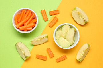 Fresh sliced carrot and apple on color background, flat lay. Finger food