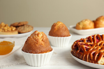 Delicious fresh pastry on white wooden table