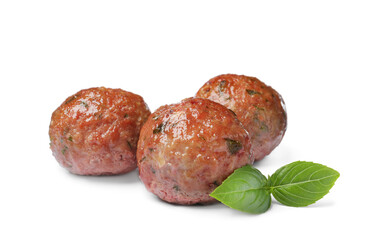 Many tasty cooked meatballs with basil on white background