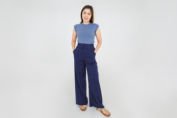 Fototapeta na wymiar Smart Asian woman confidently standing with hands in trouser pocket and lovely smile with convinced on casual outfit lifestyle