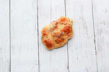 Bread is a staple food prepared from a dough of flour and water, usually by baking.