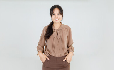 Lovely Asian girl cheerfully smile as friendly emotion and confident while standing with  happy face and attractive charming brown blouse as pretty casual outfit for female lifestyle.