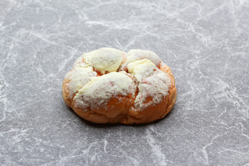 Bread is a staple food prepared from a dough of flour and water, usually by baking.