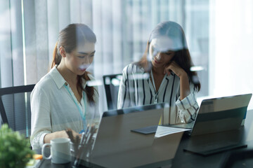 Businesswomen working, planning business model for new product.