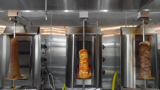 4k Loop4-5 Mixed Grill Trio Vertical Rotisserie from left to right Beef Donair, Marinated Chicken Shawarma, and thinly sliced seasoned beef shawarma steaks stacked onto an upright stainless steel BBQ.