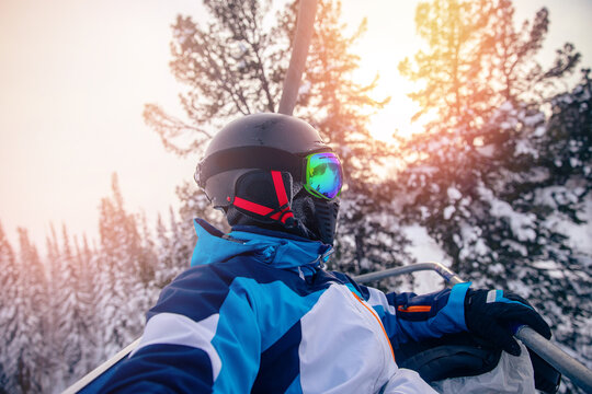 Concept active trip in resort. Skier man in helmet and glasses make selfie on mountain ski lift