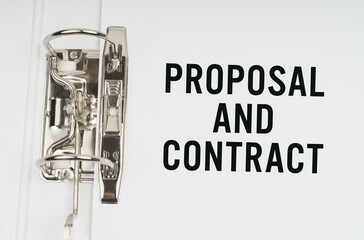 In the folder under a paper clip there is a white sheet with the inscription - Proposal and contract