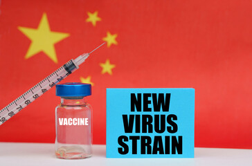 Vaccine, syringe and blue plate with the inscription - new virus strain. In the background the flag of China