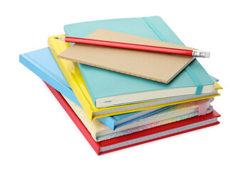 Stack of different colorful hardcover planners and pencil on white background