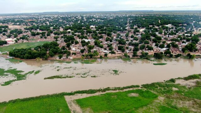 The flooded banks of the Sokoto River in Argungu Town of Nigeria in the Kebbi State - sliding aerial view