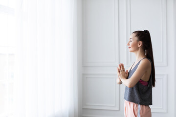 Fototapeta na wymiar Morning yoga class at home. Praying.