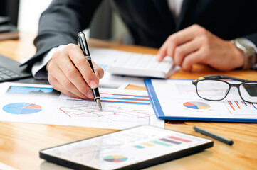 businessman working at office with document on his desk, doing planning analyzing the financial report, business plan investment, finance analysis concept.