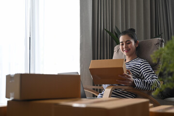 Start up small business entrepreneur preparing parcel box of product for deliver to customer.